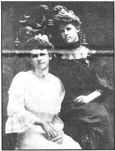 Two young ladies dressed in the height of fashion