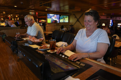 Tami Kobold plays video poker at the Topaz Lodge, in Gardnerville, Nev., on Wednesday, July 26, 2023. Photo by Cathleen Allison/Nevada Momentum Fueled by RAD